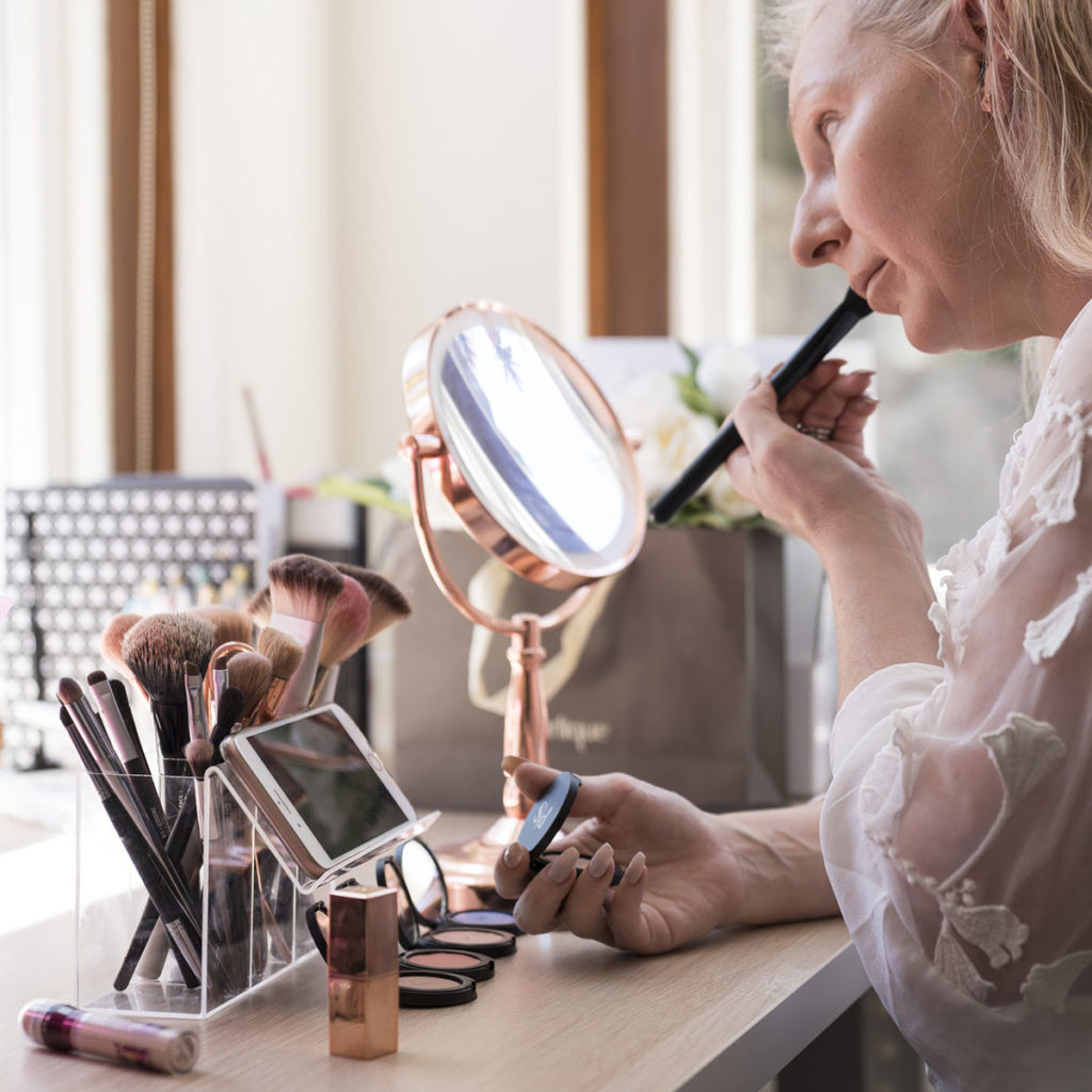 Patting on the blush, luminiser and bronzer.